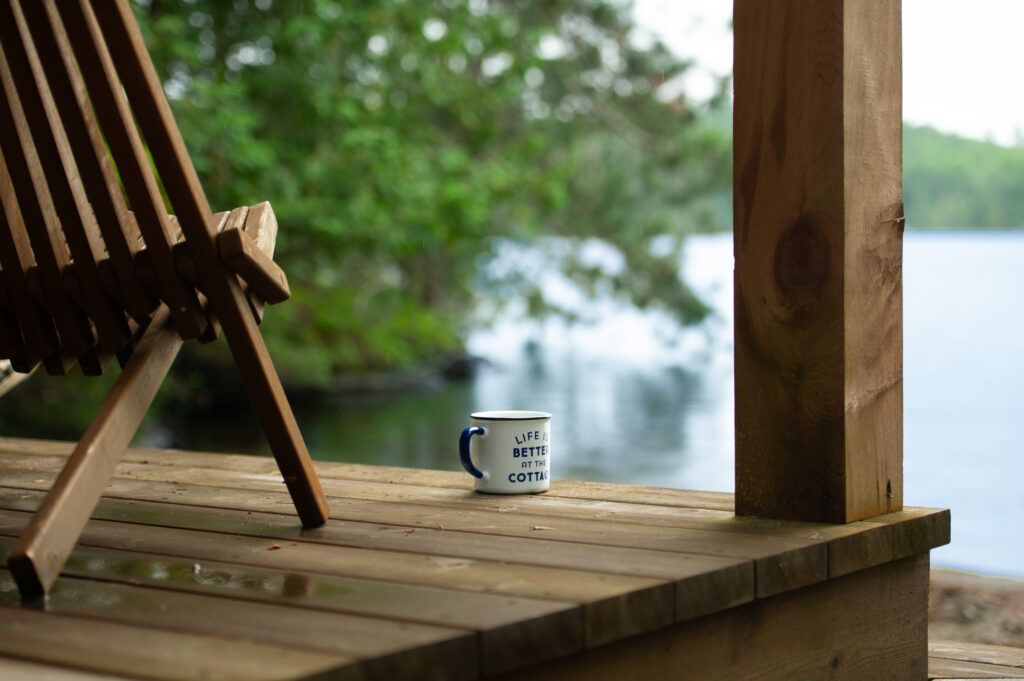 A deck chair overlooking a lake at a family cottage