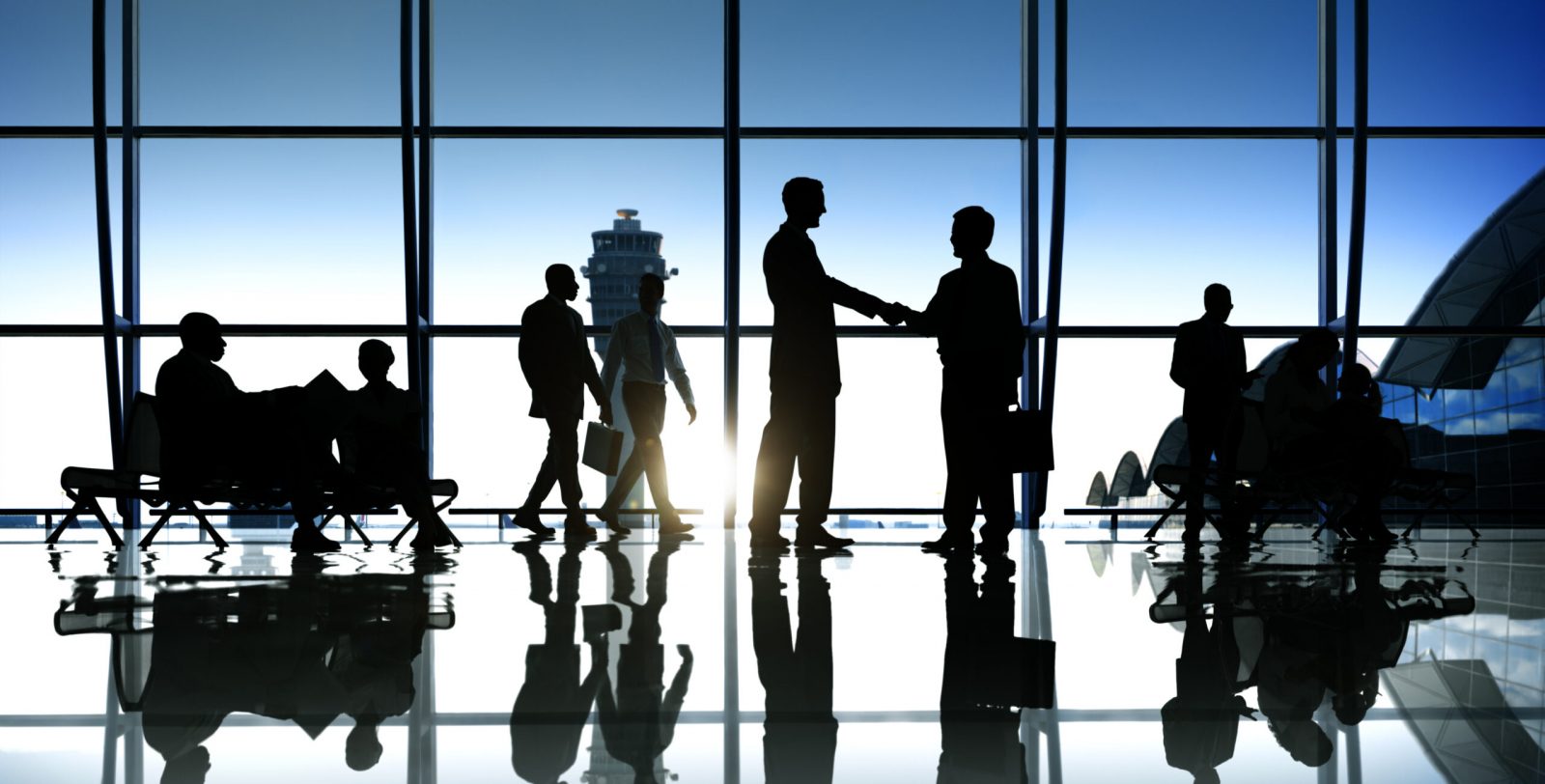 business people at an airport discussing new trade markets