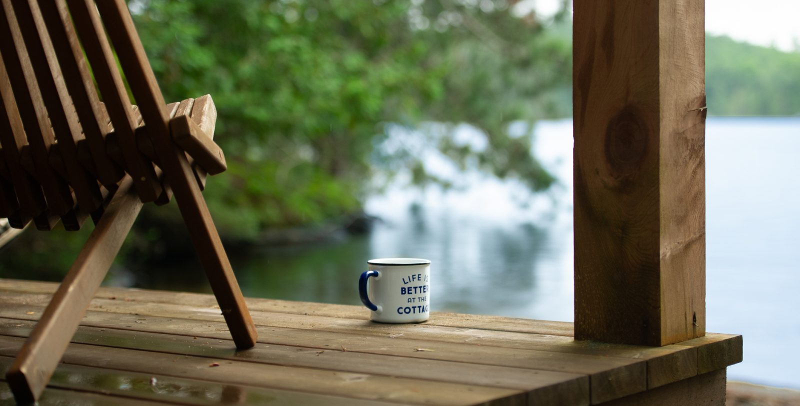 A deck chair overlooking a lake at a family cottage